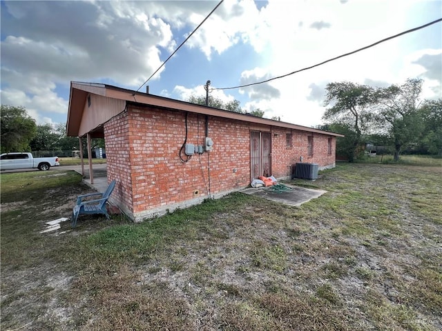 1116 S Orange St, Mercedes, TX 78570 - view of side of home featuring brick siding and a carport