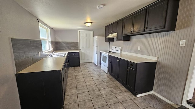 kitchen featuring light tile patterned floors, white electric stove, and sink