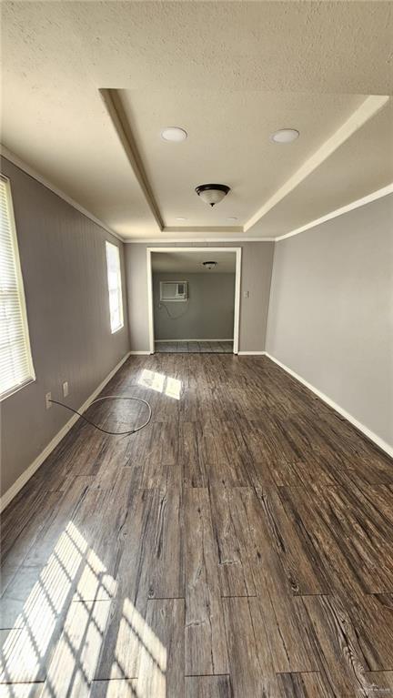 spare room featuring ornamental molding, a textured ceiling, and hardwood / wood-style flooring