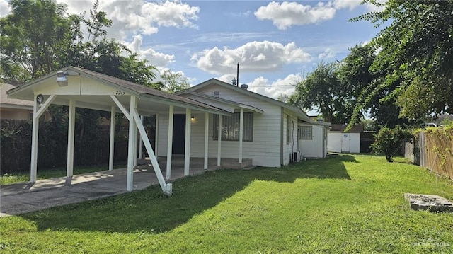 rear view of property with a lawn