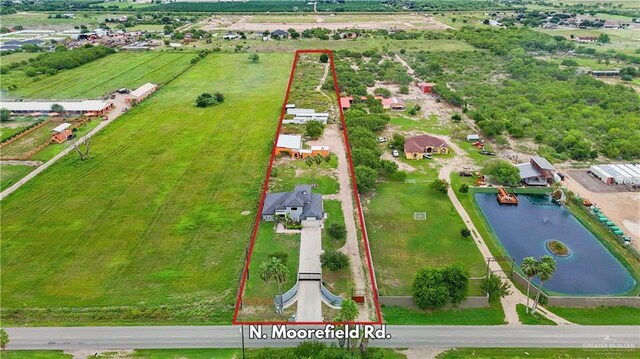 birds eye view of property with a rural view and a water view