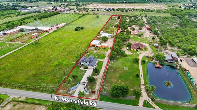 birds eye view of property with a rural view