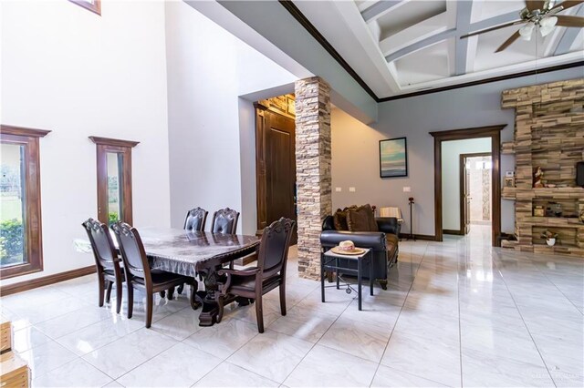 dining room with a high ceiling, ceiling fan, coffered ceiling, and light tile patterned flooring