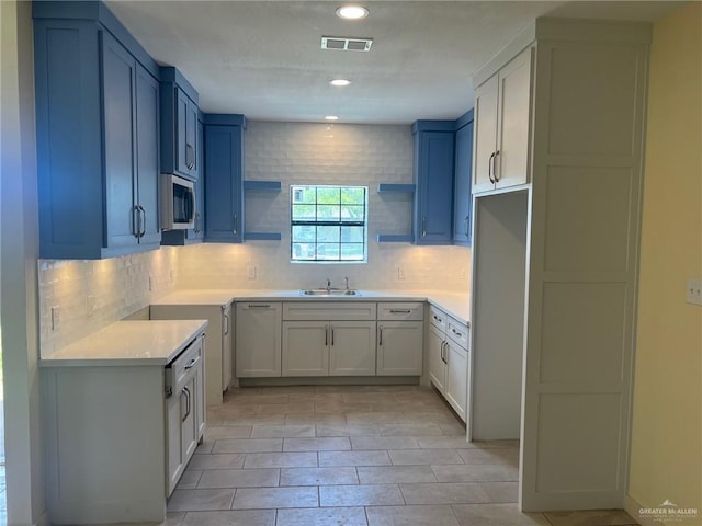 2119 N Ruby St, Edinburg, TX 78541 - kitchen featuring stainless steel microwave, tasteful backsplash, open shelves, light countertops, and recessed lighting