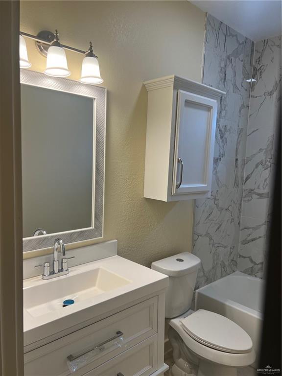 2119 N Ruby St, Edinburg, TX 78541 - full bathroom with vanity, bathtub / shower combination, and a textured wall