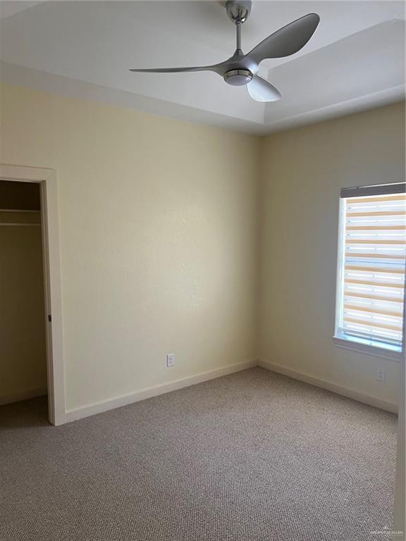 2119 N Ruby St, Edinburg, TX 78541 - unfurnished bedroom featuring carpet and ceiling fan