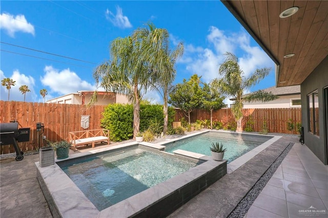 view of swimming pool with a fenced backyard, a patio, and a pool with connected hot tub