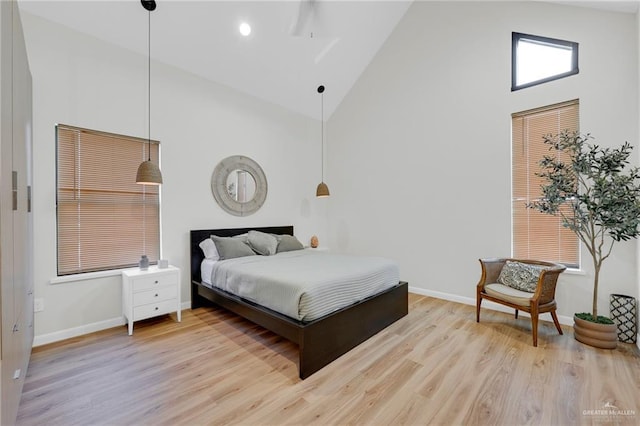 bedroom featuring light wood-style floors, high vaulted ceiling, baseboards, and recessed lighting
