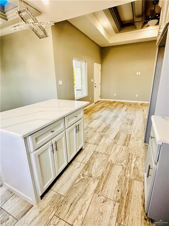 kitchen featuring white cabinets and light stone counters