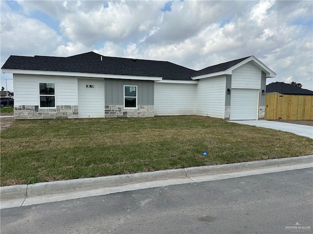 ranch-style home featuring a garage and a front lawn