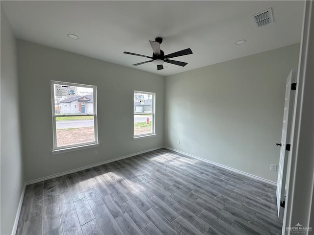 unfurnished room with dark wood-type flooring and ceiling fan