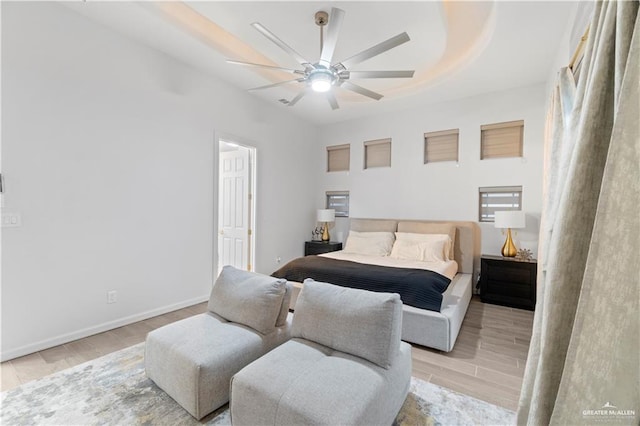 bedroom with light hardwood / wood-style floors and ceiling fan