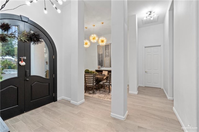 entryway featuring light hardwood / wood-style flooring and a chandelier