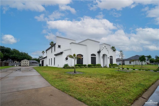 view of front of property with a shed and a front yard