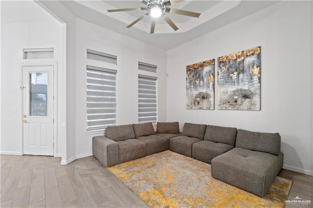 living room featuring ceiling fan and light hardwood / wood-style floors