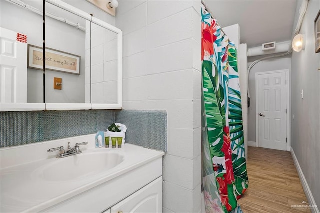5805 Gulf Blvd, South Padre Island, TX 78597 - bathroom featuring wood finished floors, vanity, and a shower with curtain