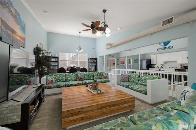 5805 Gulf Blvd, South Padre Island, TX 78597 - living area with a chandelier, wood finished floors, and a ceiling fan