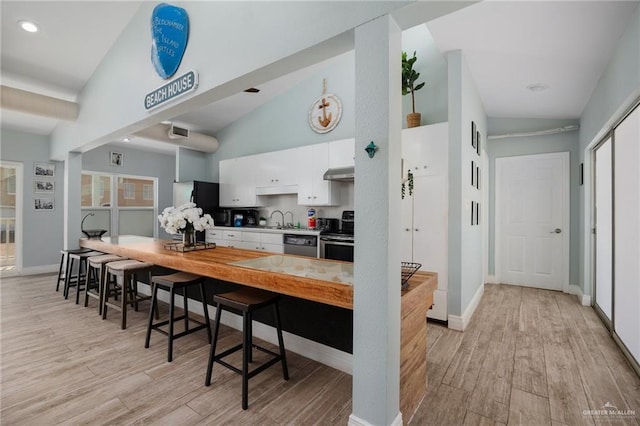 5805 Gulf Blvd, South Padre Island, TX 78597 - kitchen featuring vaulted ceiling, dishwasher, light wood-type flooring, electric range, and recessed lighting