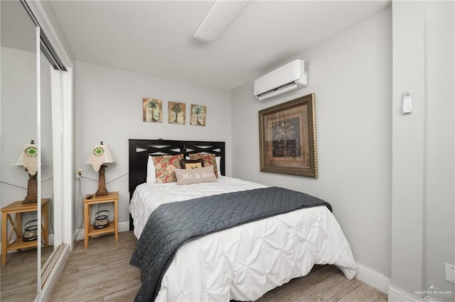 5805 Gulf Blvd, South Padre Island, TX 78597 - bedroom featuring a wall mounted AC, wood finished floors, and a ceiling fan