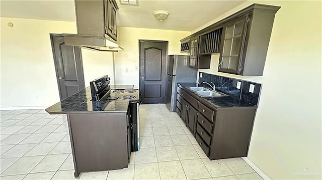 kitchen featuring stainless steel fridge, dark brown cabinetry, sink, light tile patterned floors, and electric range