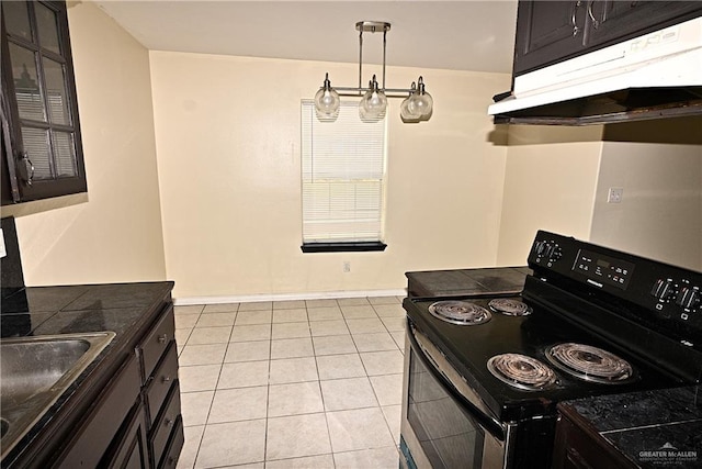 kitchen with black electric range oven, light tile patterned flooring, and dark brown cabinetry