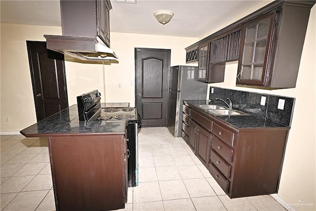 kitchen featuring black range with electric cooktop, dark brown cabinetry, wall chimney range hood, sink, and light tile patterned flooring