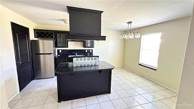 kitchen with stainless steel refrigerator, an inviting chandelier, tasteful backsplash, pendant lighting, and light tile patterned floors