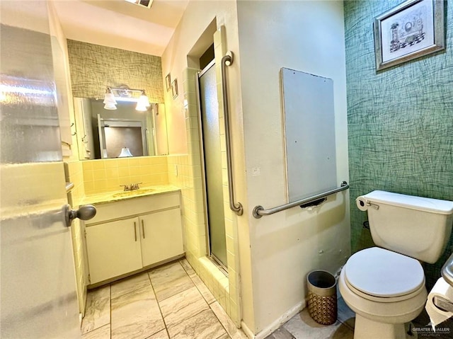 bathroom featuring vanity, backsplash, toilet, and walk in shower