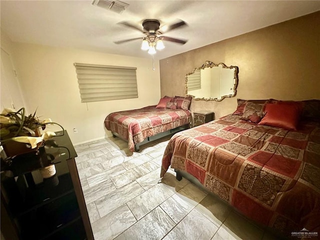 tiled bedroom featuring ceiling fan