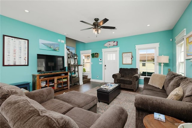 living room with ceiling fan and light hardwood / wood-style flooring