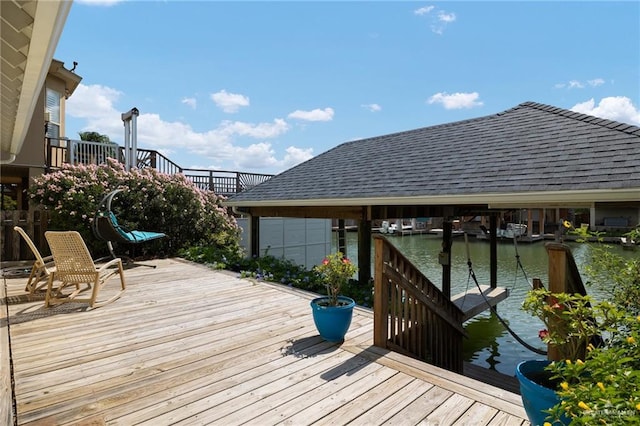 wooden terrace featuring a boat dock and a water view