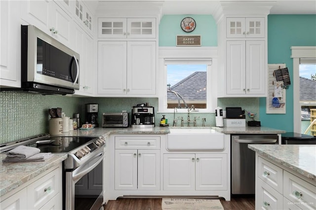 kitchen featuring white cabinetry, stainless steel appliances, and dark hardwood / wood-style floors