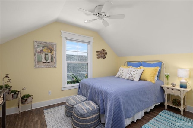 bedroom with ceiling fan, dark wood-type flooring, and lofted ceiling