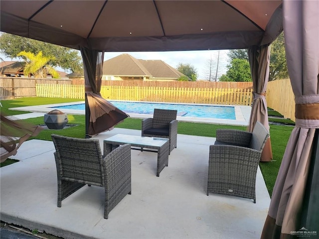 view of patio with a gazebo and a fenced in pool