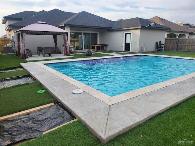 view of pool featuring a gazebo, a lawn, and a patio area