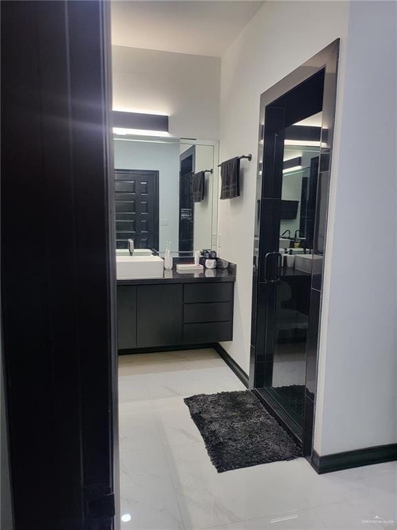 bathroom with walk in shower and vanity