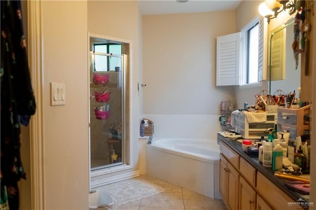 full bath featuring tile patterned floors, a garden tub, a shower stall, and vanity