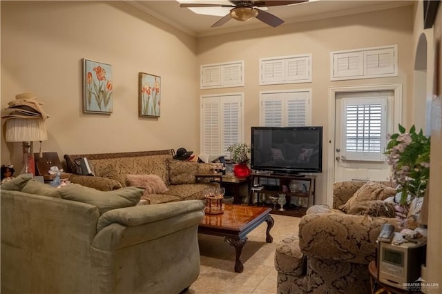 living area featuring crown molding, light tile patterned flooring, and ceiling fan