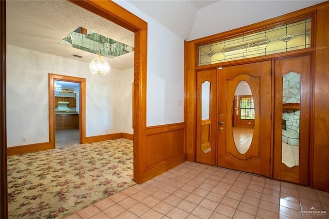 entrance foyer featuring a chandelier and light tile patterned floors