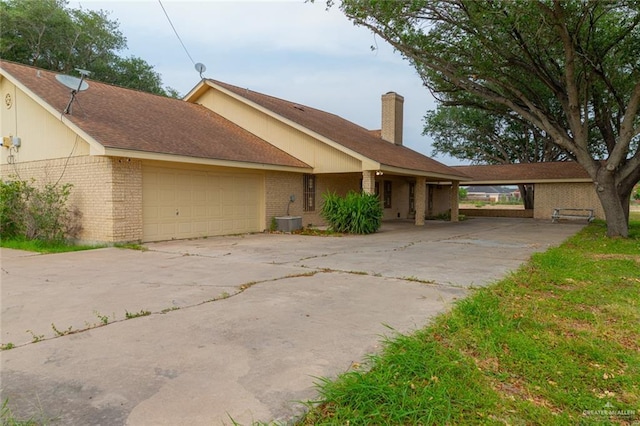 ranch-style house featuring a carport and a garage