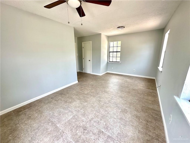 unfurnished room featuring ceiling fan and a textured ceiling