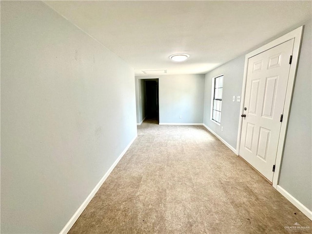 unfurnished room featuring light colored carpet