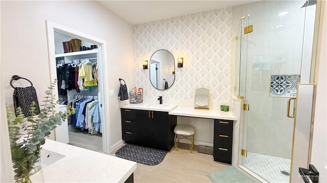 2800 Encke Rd, Mission, TX 78574 - full bath with vanity, a stall shower, a spacious closet, and an accent wall