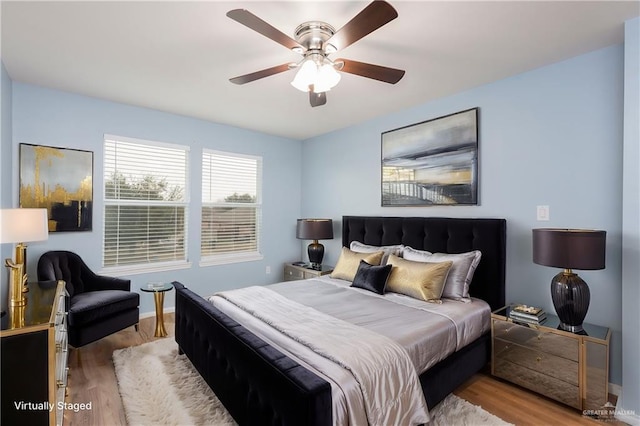 bedroom with ceiling fan and light hardwood / wood-style floors