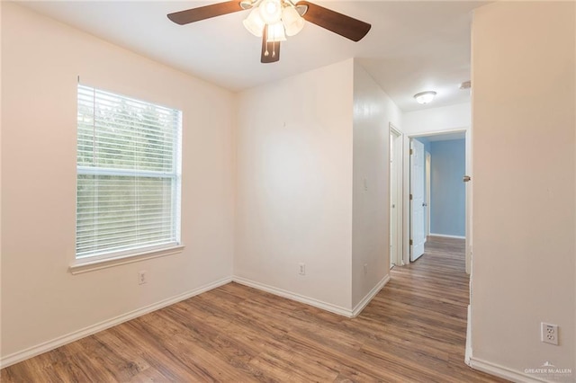 unfurnished room with hardwood / wood-style flooring and ceiling fan