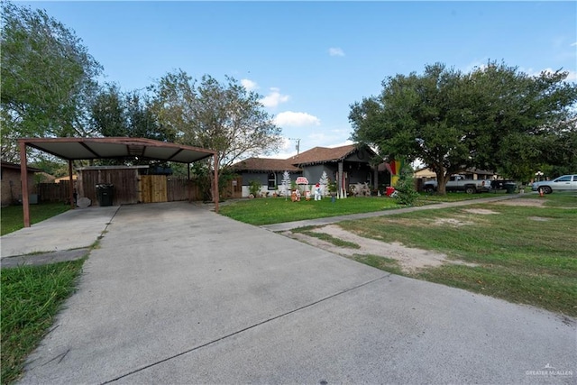 view of front facade with a carport and a front lawn