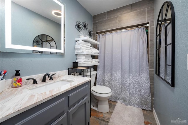 bathroom featuring vanity, toilet, and walk in shower