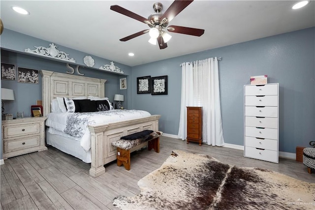 bedroom with ceiling fan and wood-type flooring