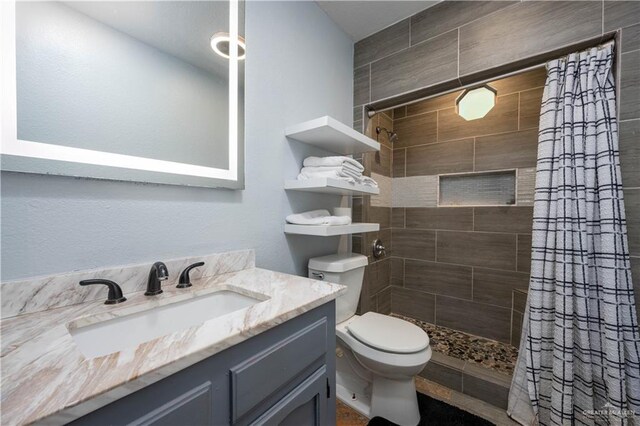 bathroom featuring a shower with curtain, vanity, and toilet