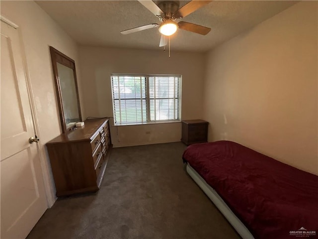 bedroom featuring ceiling fan and dark colored carpet